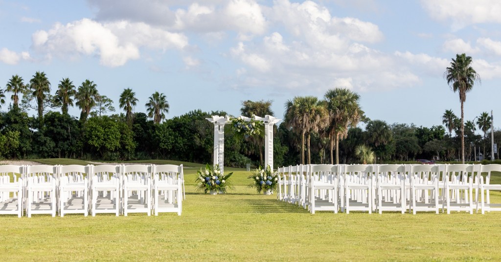 Palm Beach Florida wedding venue outdoor ceremony with luxury chairs and arch