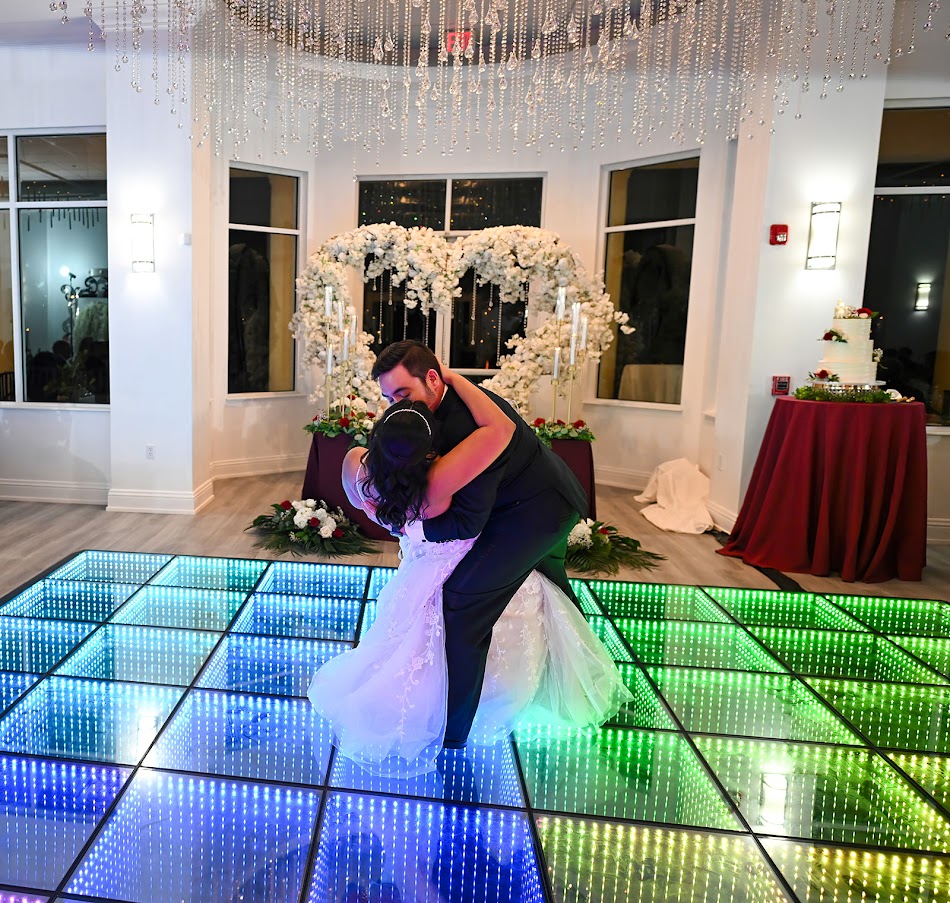 Palm Beach wedding venue reception bride and groom dance as a wedding photography takes photos.